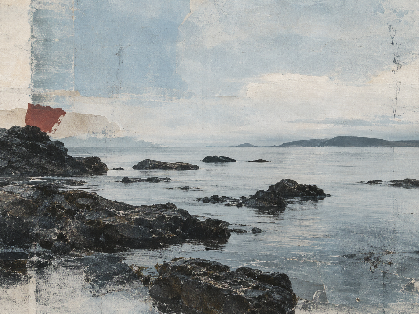 Rocky shoreline extending into calm grey-blue water beneath a pale cloudy sky.